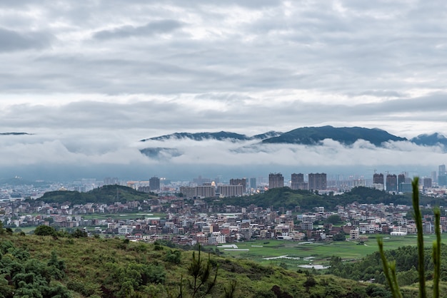 In the town after the rain, there are clouds in the mountains in the distance