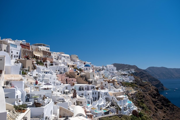 Townscape by sea against clear blue sky