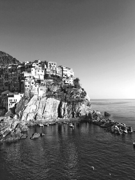 Townscape by sea against clear sky