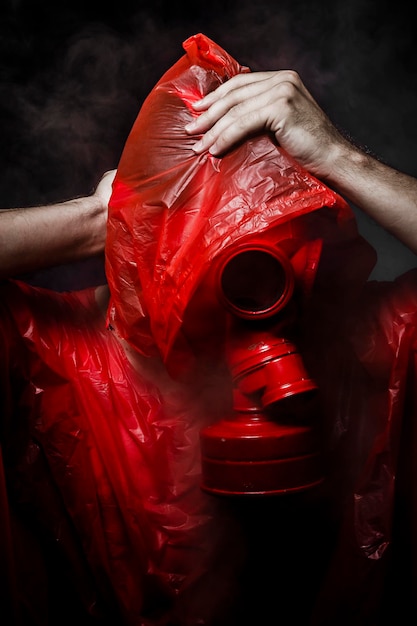 Toxic horror concept, man with red gas mask.