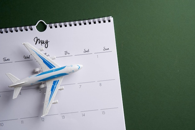 Toy air plane on white wall calendar