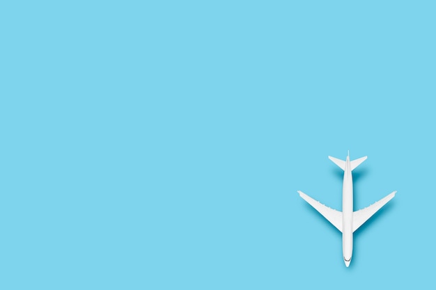 Toy airplane on a blue background. Concept travel, airline tickets, flight.