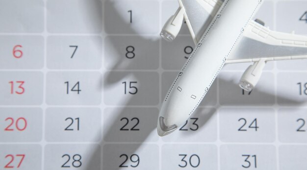 Toy airplane on calendar Travel