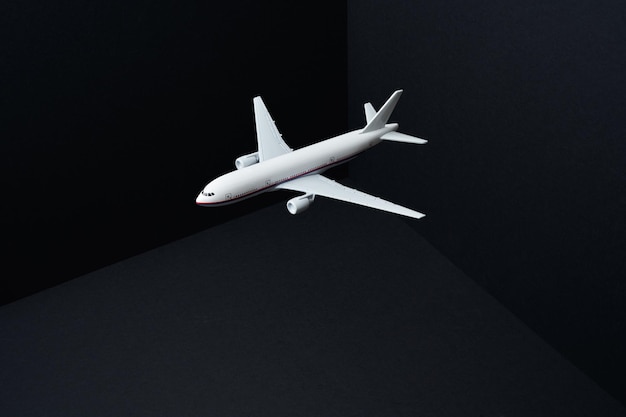 Toy airplane fly on mockup three dimensional black background ,travel concept