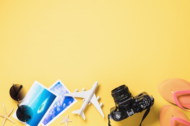 Toy airplane glasses photos and camera on a yellow surface