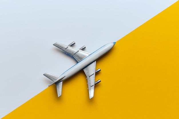 Toy airplane on a yellow and white background.