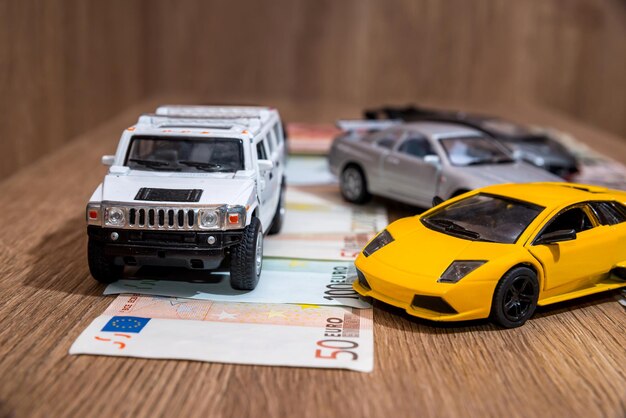 Toy automobile euro bill on desk