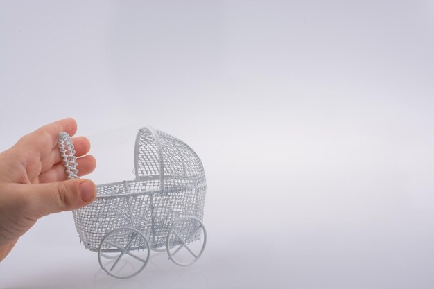 Toy baby carriage in hand