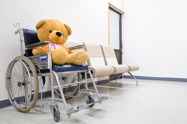 A toy bear on a wheel chair