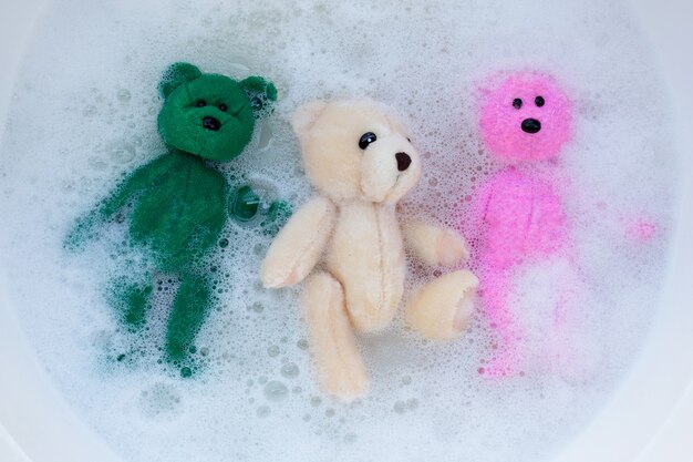 Photo toy bears in laundry detergent water