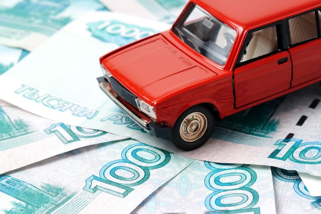 Toy car on the background of banknotes.