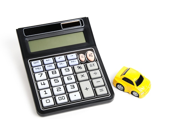 Toy car and calculator white backgroundConcept buying car