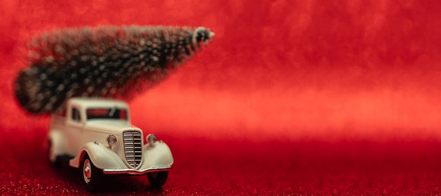 Toy car carries Christmas tree for holiday