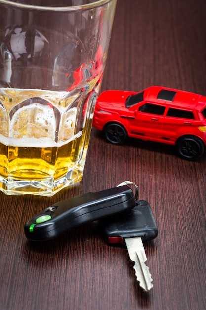 Toy car and glass of whiskey metaphor crash accident isolated