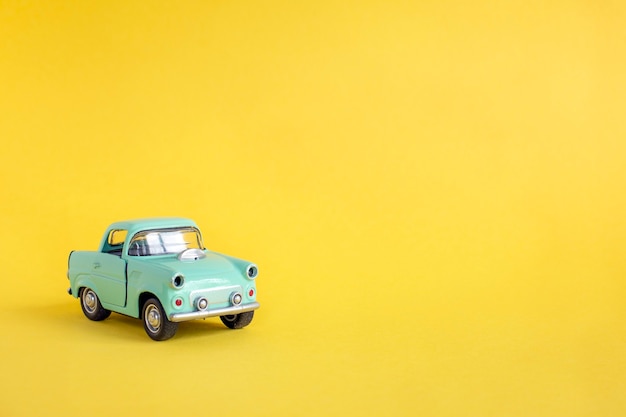 Toy car on the road on a yellow background