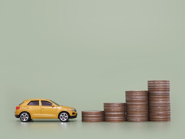 Toy car and stack of coins The concept of saving money and manage to success transport business