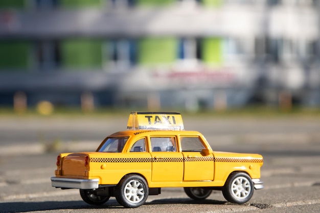 Toy car taxi on the background of the city