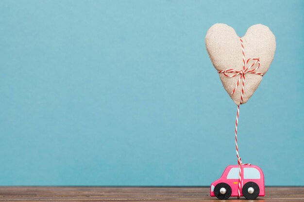 Toy car with a foating love heart Valentines day mothers day concept