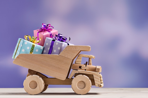 Toy car with gift boxes in festive wrapper.