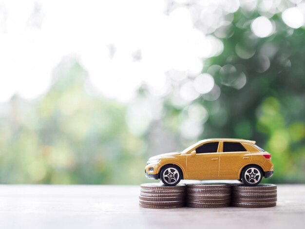 Toy cars on stack of coins The concept of saving money and manage to success transport business