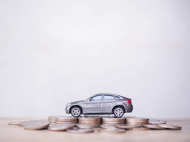 Toy cars on stack of coins The concept of saving money and manage to success transport business