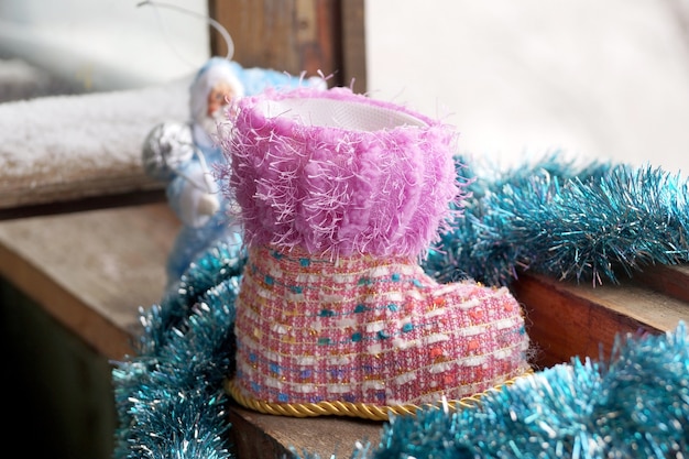 Toy Christmas boot at a winter window