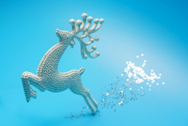 A toy deer galloping along a sparkling path The symbol of Christmas and New Year