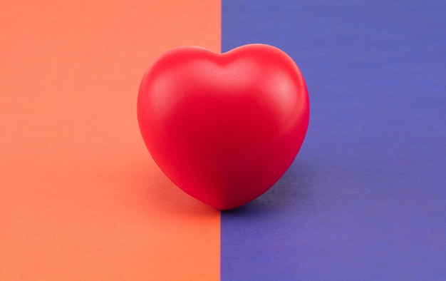 Toy heart on a colored background. Concept healthcare. Cardiology - care of the heart