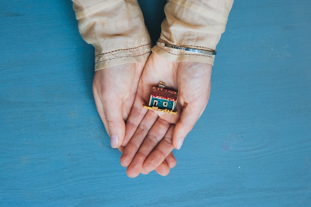 Toy house in the hand 