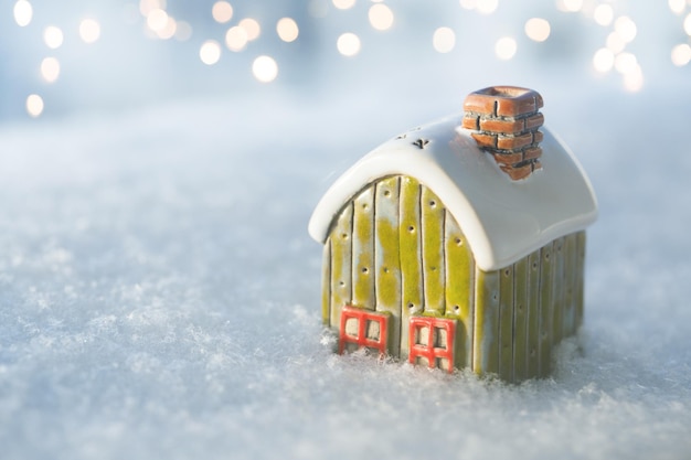 Toy house on snow natural abstract background Copy space