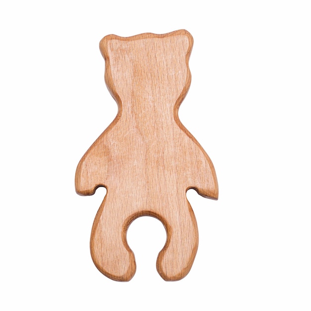 The toy is a wooden bear cub isolated on a white background