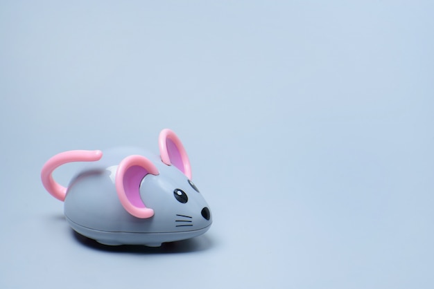 Photo toy mouse on a gray wall