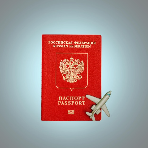 Toy plane and Russian passport The concept of the beginning of the tourist season