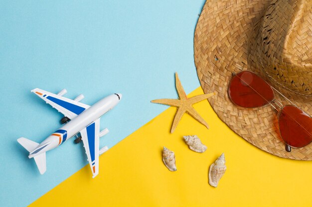 A toy plane with passport and money on a yellow and light blue background