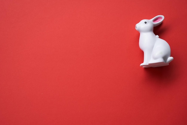 Toy rabbit on red background year of rabbit