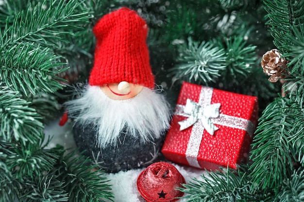 Toy Santa in the branches of a spruce.