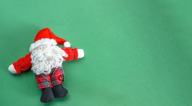 Toy Santa on green background