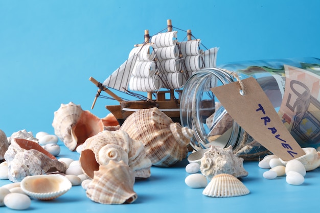 Photo toy ship, money jar and seashells