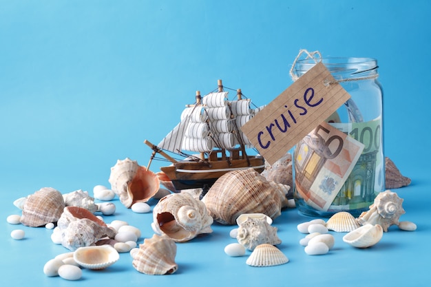 Toy ship, money jar and seashells