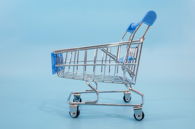 toy shopping cart on a blue surface