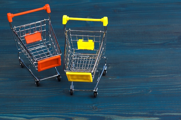 Toy shopping cart on blue wooden