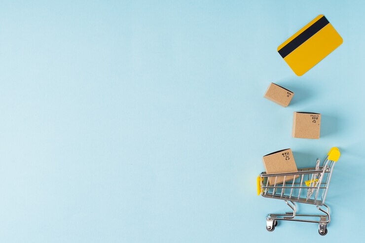 Toy shopping cart with boxes and credit card with copy space