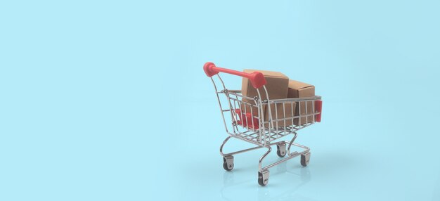 Toy shopping cart with boxes shopping and delivery concept. Consumer society trend