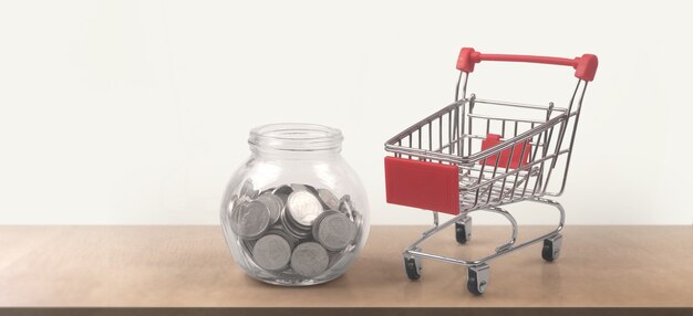 Toy shopping cart with coins and Piggy bank