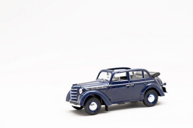 Toy small model of a retro car on a white background isolate