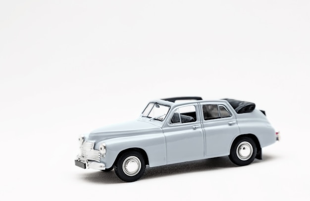 Toy small model of a retro car on a white background isolate