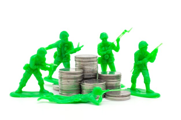 Toy Soldier on coin stacks a white background