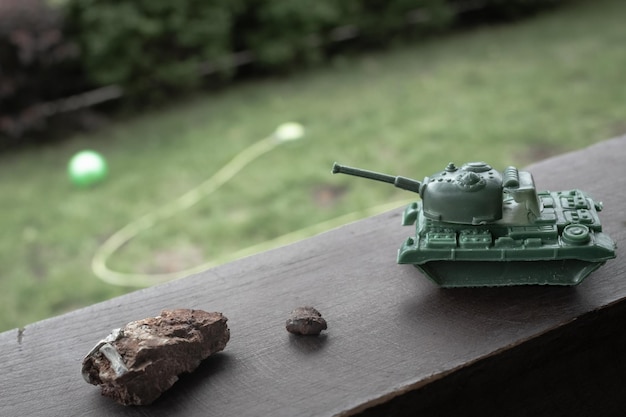 Toy tank. Shell fragment. War in Ukraine. The consequences of Russian aggression.
