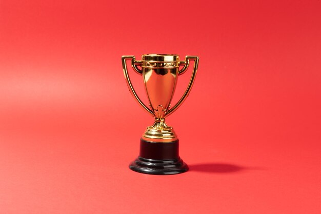 Toy throphy on red background