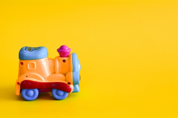 Toy train on yellow background.